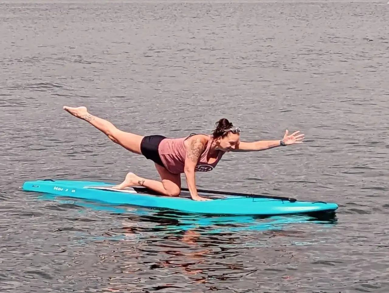 A Woman Doing Yoga While on a Surf Boat